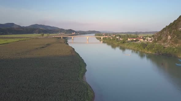 Aerial View River Between Small Town and Green Peanut Fields