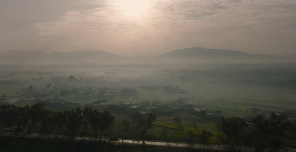 Aerial View Across Rural Misty Landscape In Abbottabad In Pakistan. Circle Dolly Establishing Shot