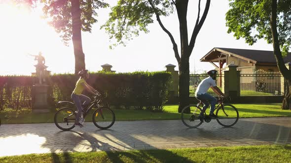 Four Young Persons Cycling in Public Park