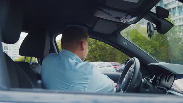 Young businessman driving a car