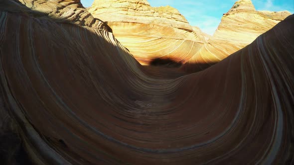 Gliding view walking through the Wave as the sun lights up part of it.