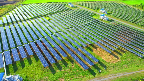 Drone fly over solar farm, renewable energy from solar.