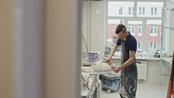 Man Shaping Plaster Cast