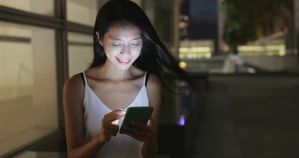 Woman use of mobile phone at night 