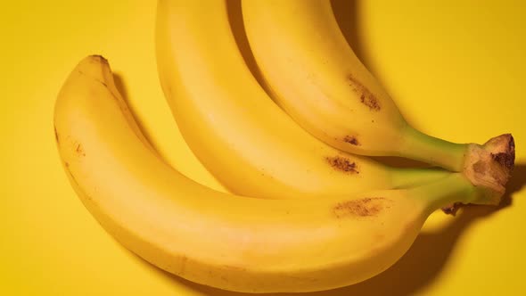 Fresh Bananas on a Yellow Minimalistic Background