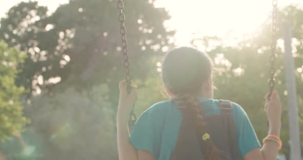 Children swinging together at a public playground