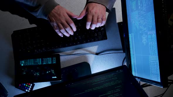 Overhead shot of computer hacker typing code