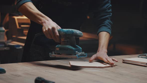 Close Up of a Carpenters Hands with a Grinder