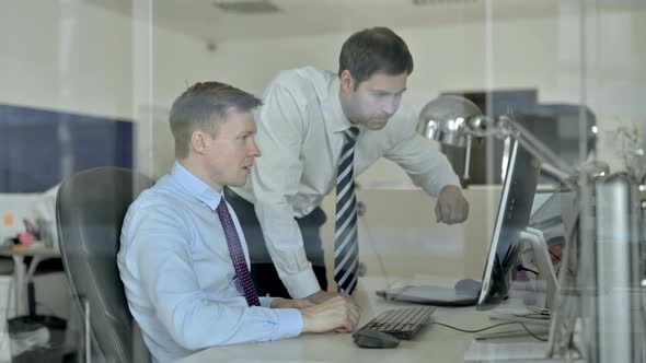 Mature Businessmen Celebrating with Both Fest While Using Office Computer