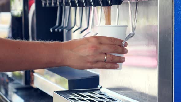 Man Pouring Beverage From Dispenser