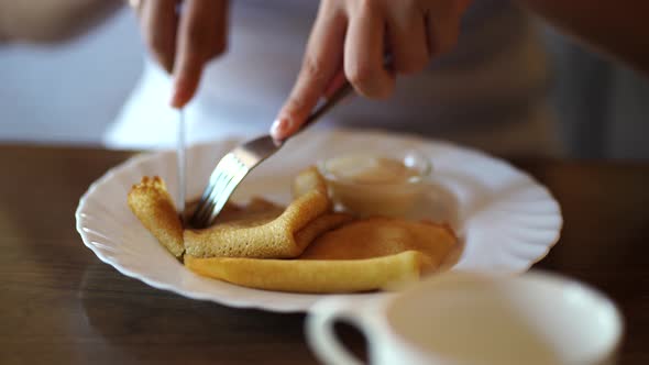 Woman Has Breakfast Pancakes in Cafe