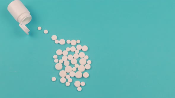 4K Stop motion animation of white pill on blue background