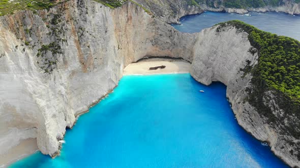 A Drone Flies Back Over Shipwreck Beach of Zakynthos Island on a Sunny Day