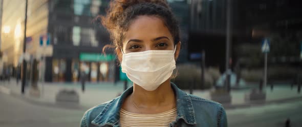 Video portrait of woman in protective mask on the street. Shot with RED helium camera in 8K.