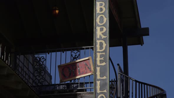 Old west town bordello sign on building for prostitution and whiskey