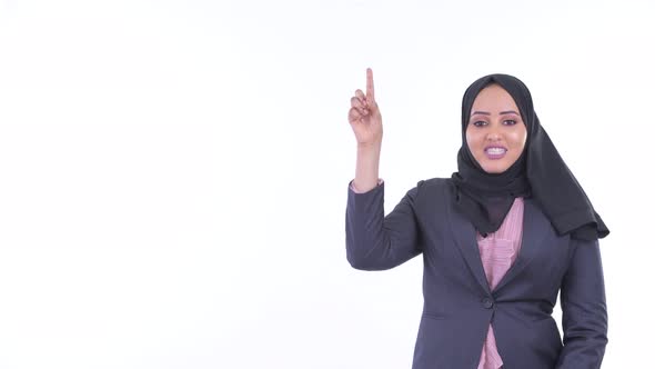 Happy Young African Muslim Businesswoman Talking While Pointing Up