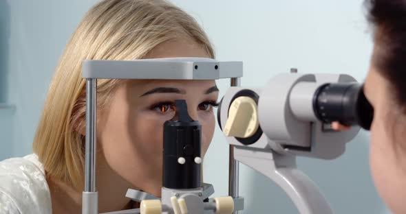 Young Woman Having Her Eyes Examined With Modern Medical Equipment Vitiligo