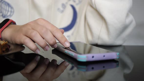 Young Woman Using App on Cellphone at Home