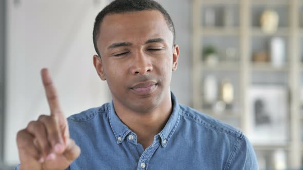 No, Young African Man Rejecting Offer by Waving Finger