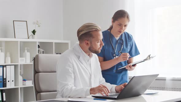 Professional medical doctors working in hospital office. Physician and the young nurse.