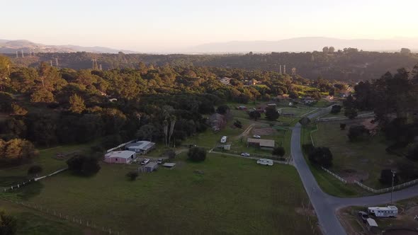 Tiny rural town of Prunedale on sunny day, aerial flying over view