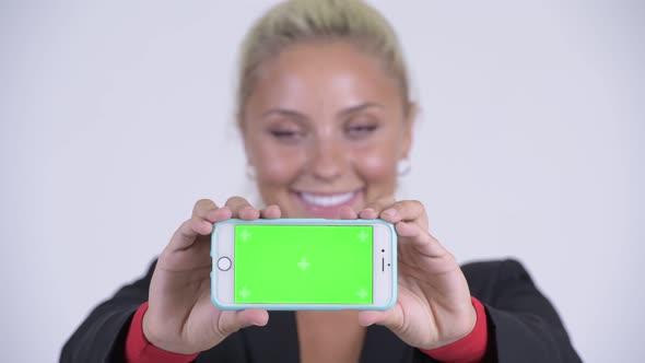 Face of Young Happy Blonde Businesswoman Showing Phone