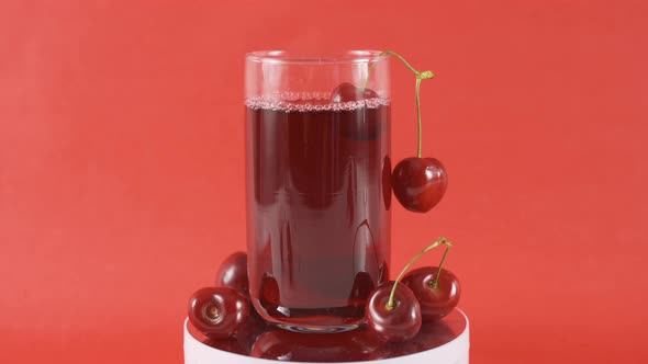 Cherry juice in a swirling glass.