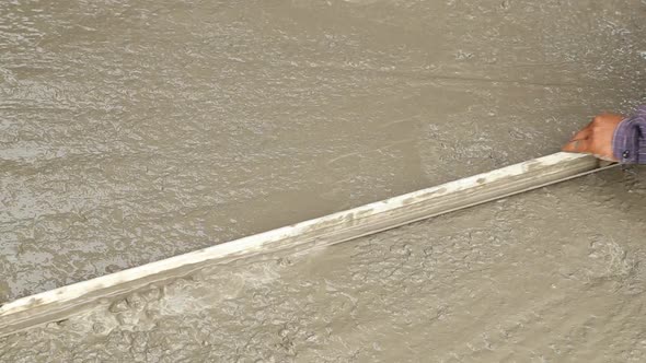 wood trowel working to smooth concrete ground