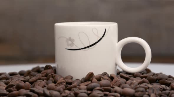 a hot cup of turkish coffee among the coffee grains on the rotating table