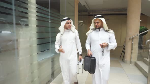 Arabic Men Go and Talk in Business Center