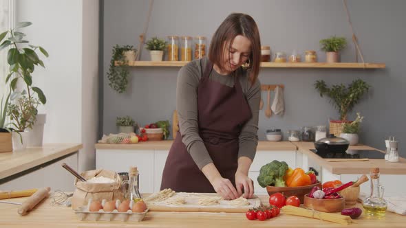 Woman Preparing Homemade Pasta in Kitchen