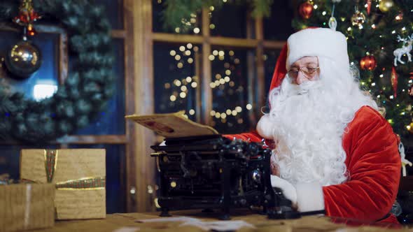 Santa Claus Writing Letters on the Typewriter