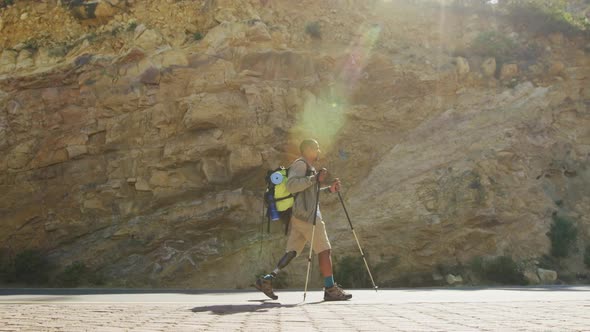 Sporty mixed race man with prosthetic leg hiking