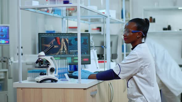 African Doctor Woman Smiling at Camera While Working in Modern Equipped Laboratory