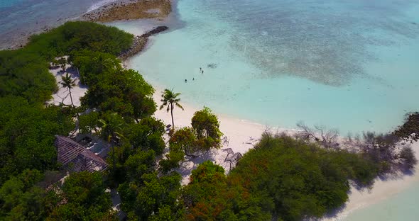 Luxury aerial island view of a paradise sunny white sand beach and blue sea background in high resol