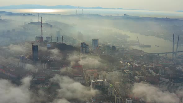 The Mystical Morning City with Houses Shrouded in Fog