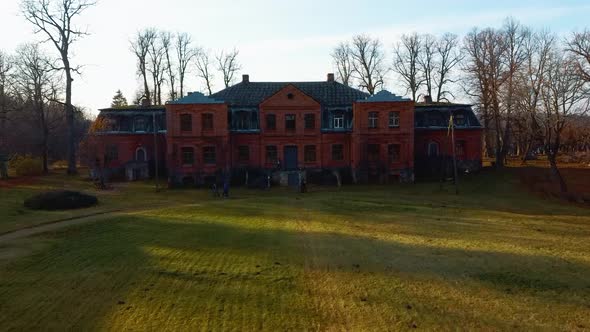 Old Red Brick House, Katvari Manor in Latvia and Katvaru Lake in the Background