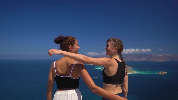 Two Sporty Tourist Girls Reached the Top of Mountain and Happy with That Hugging and Enjoy the View