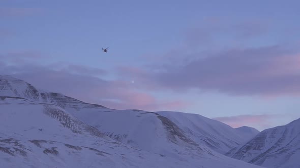 Helicopter Over the Snowy Mountains of Svalbard