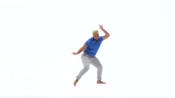 Man Practicing Capoeira in White Background of Studio. Afro-Brazilian Martial Art That Combine