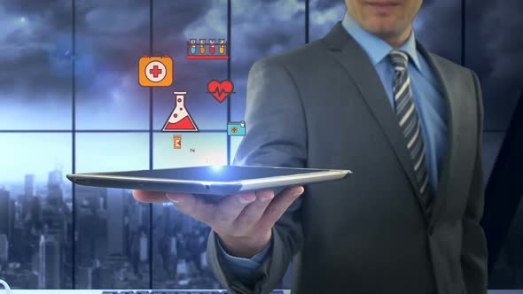 Man showing digitally generated medical icons on tablet