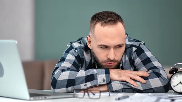 Tired Male Sighing Feeling Fatigue at Workplace Lying on Table
