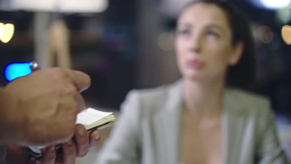 Woman Telling Order to Waiter