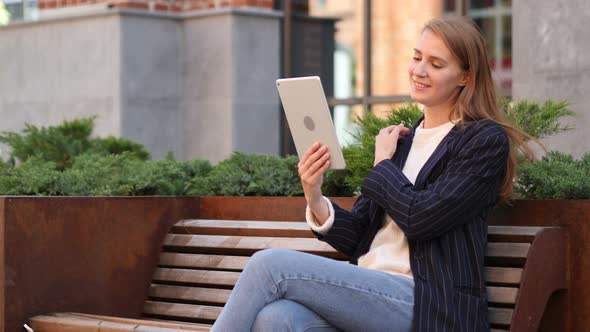 Video Chat on Tablet by Business Woman Sitting Outside Office