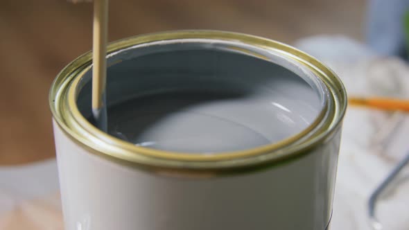 Wooden Stick Stirring Grey Color Paint in Can
