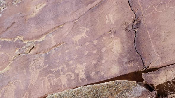 Panning view of petroglyph carvings across cliff in Nine Mile Canyon