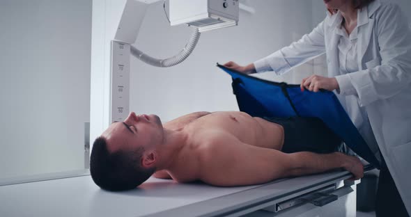 Crop Medical Practitioner Initiating X Ray Scan of Male Patient