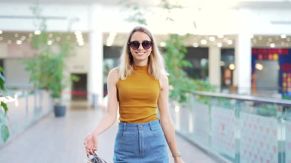 Young happy blonde Attractive woman spending leisure time at big modern mall.