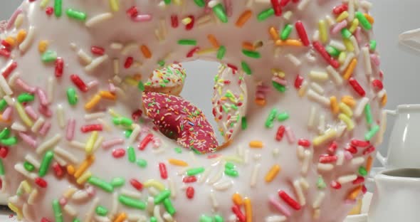 Colorful donuts with sprinkles. White and pink donuts with glaze.