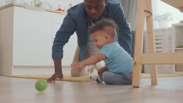 Father Playing with Child on the Floor